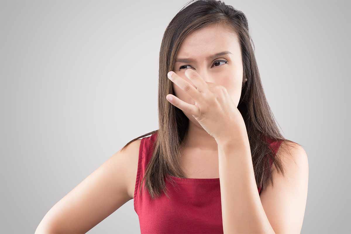 Woman holding nose due to awful musty smell