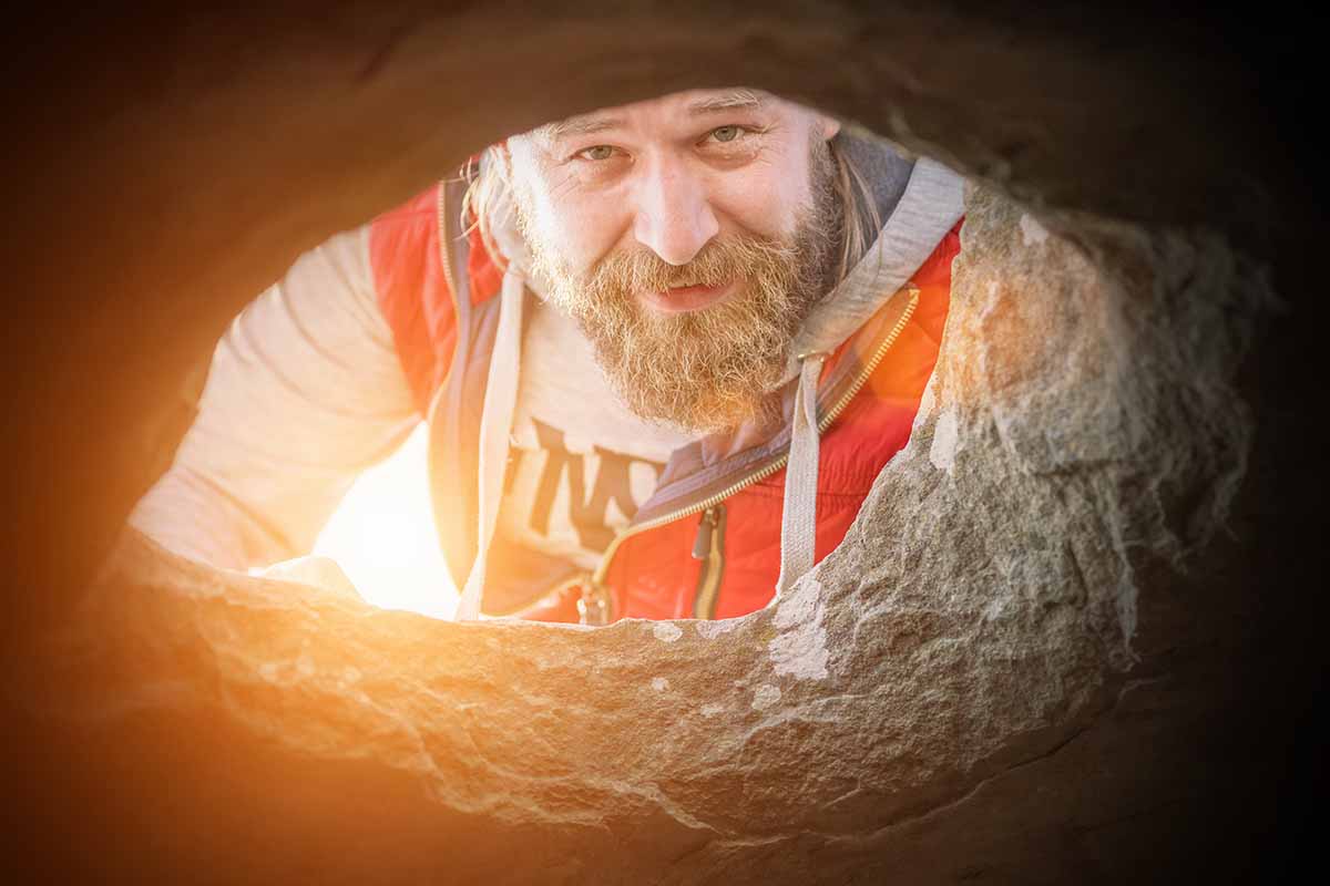 man looking in hole